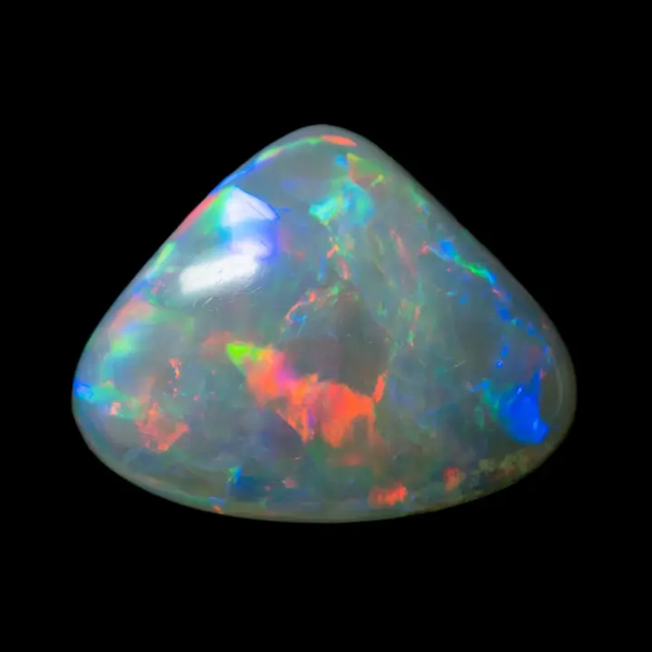 Natural Australian crystal clear opal from the Coober Pedy mines in a triangle shape with multicolored brilliance.
