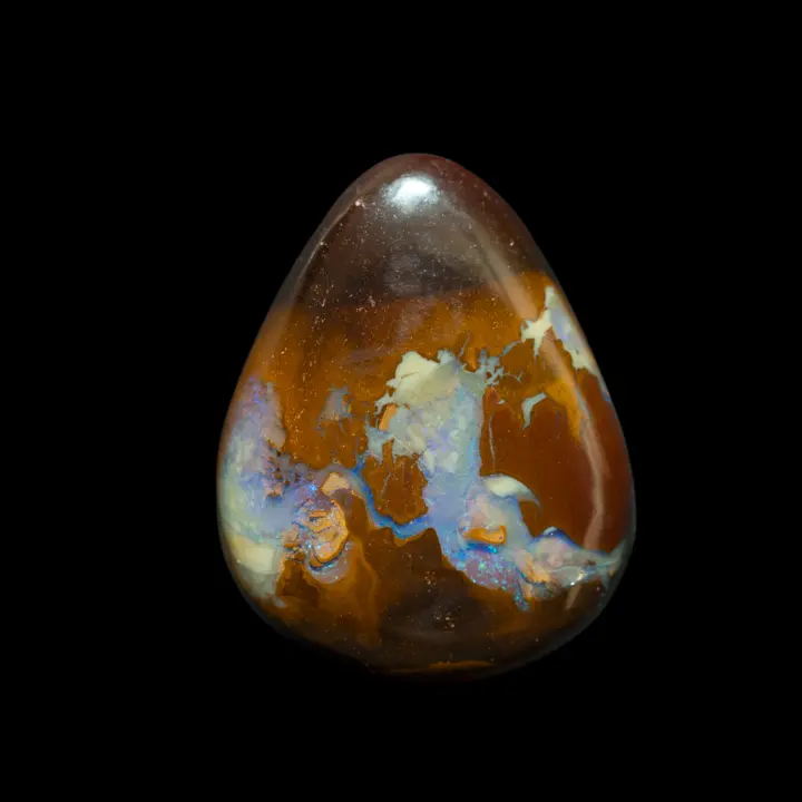 Natural Australian Koroit opal, teardrop cut 22.1 carats, the caramel-colored gangue is crossed by a beautiful crystal opalization with blue brilliance.