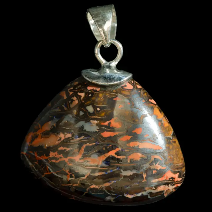 A 19.5-carat triangular-shaped natural Australian Koroit opal set in a silver pendant. Contrasting orange and brown landscape patterns accented with a diagonal streak of tiny purple sparkles