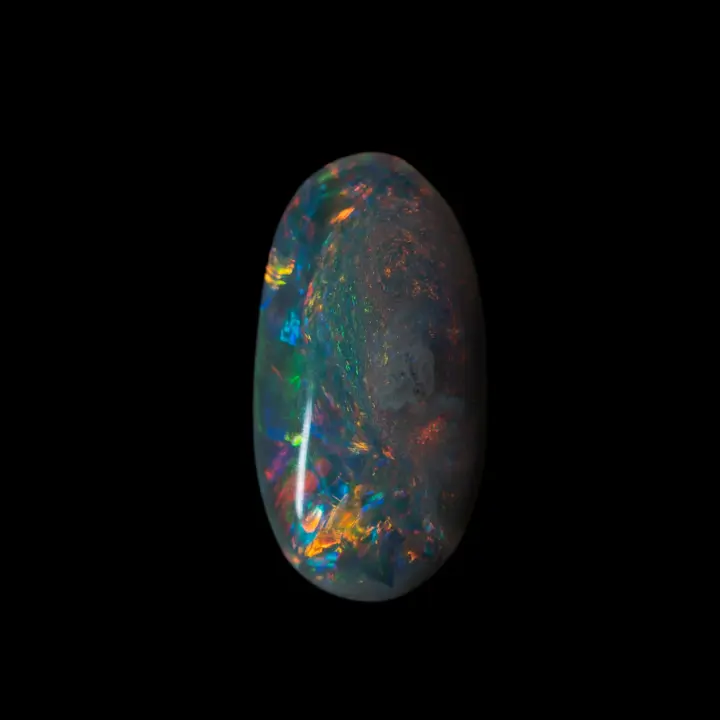 Natural Australian opal from the Lightning Ridge mines, pretty little oval of 0.4 carat, very multicoloured over a large part of its surface.