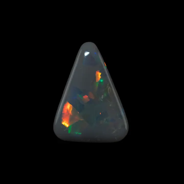 Natural Australian opal from the Lightning Ridge mines, 3 carats of dark opal cut in a triangle with beautiful luminous flashes of orange, yellow and green.