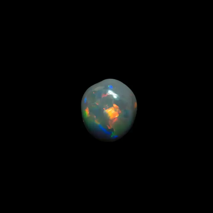Natural Australian opal from the Lightning Ridge mines, pretty little dark cabochon of 0.30 carat with dominant yellow, blue colors complemented by red and green.