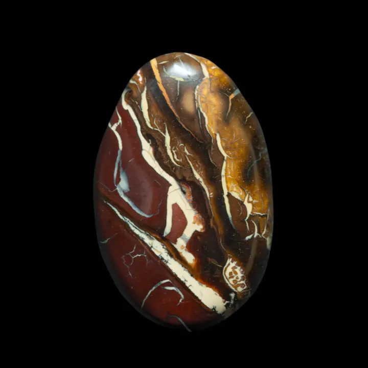 Natural Australian opal from the Koroit mines, a highly decorative oval of 36.8 carats with contrasting brown-yellow patterns highlighted in white.