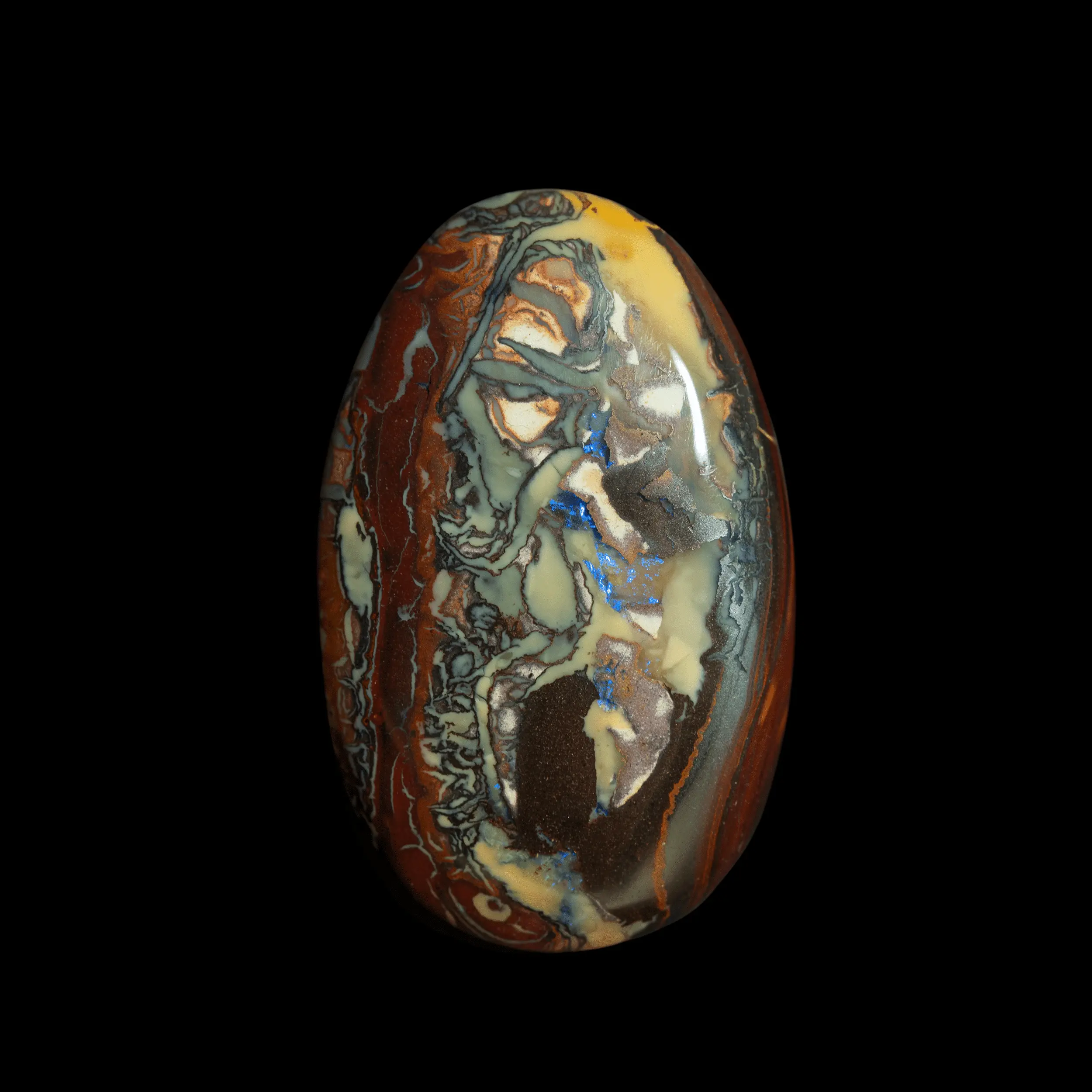 Natural Australian opal from the Koroit mines, oval cabochon of 47.9 carats with art deco motifs in yellow, brown and blue.
