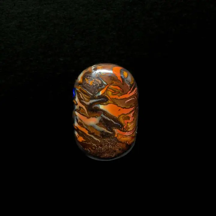 Polished rounded rectangular cabochon with geometric motifs on both sides