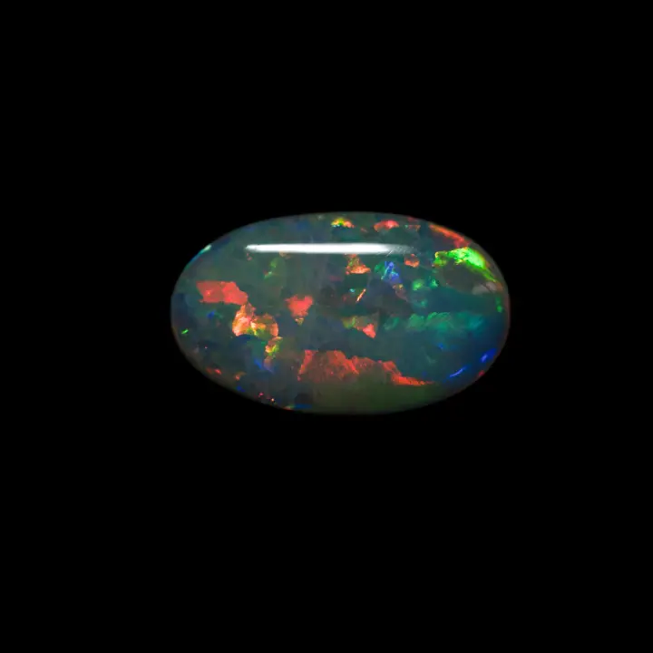 Natural Brazilian opal from the Horca mines, oval cabochon of 2.7 carats polished on one side, multicolored, predominantly orange and very bright.