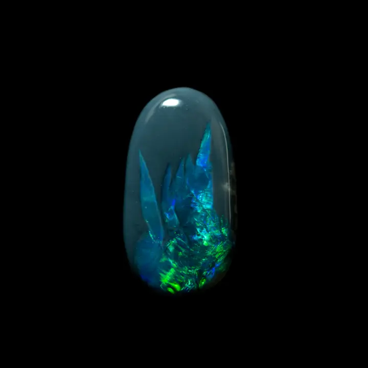 Natural Australian opal from the Lightning Ridge mines, oval cabochon of 2.6 carats with green and purple glints arranged in a bouquet of crystal-like shapes.