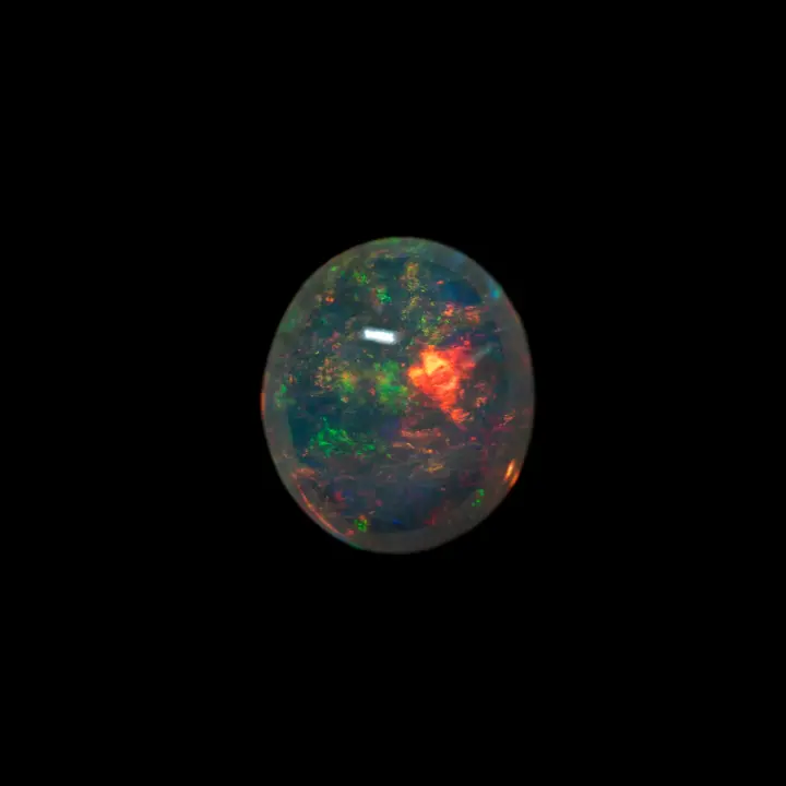 Natural Brazilian opal from the Horca mines, large cabochon of 2.40 carats of clear crystal polished on both sides; very brilliant, multicolored with a predominance of red and green on a beautiful transparency.