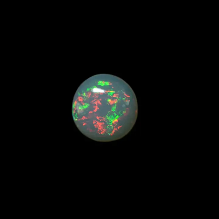Natural Brazilian opal from the Horca mines, round shape of 0.8 carat translucent, with predominantly red and green fire colors.