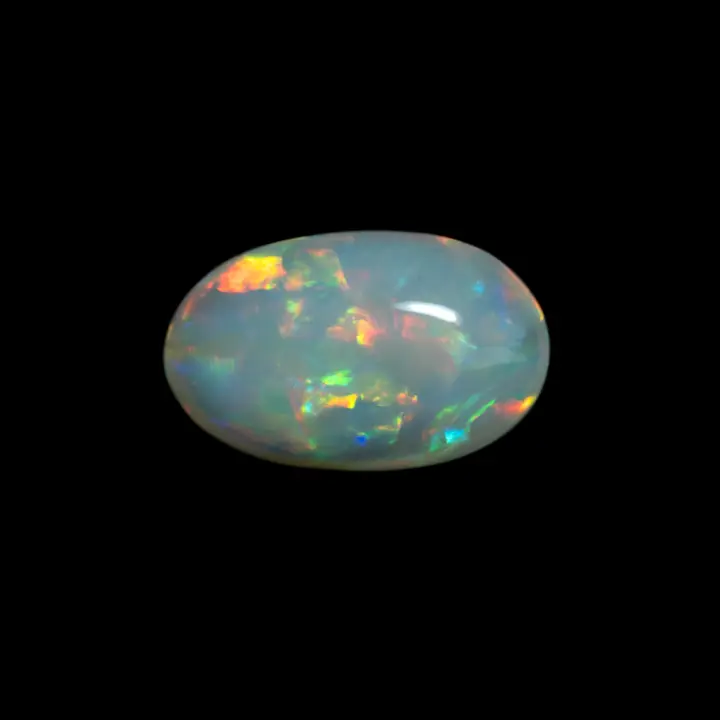 Opale naturelle australienne des mines de Coober Pedy, petit ovale clair de 0,4 carat à matrice dense à brillances multicolores à teintes très intenses