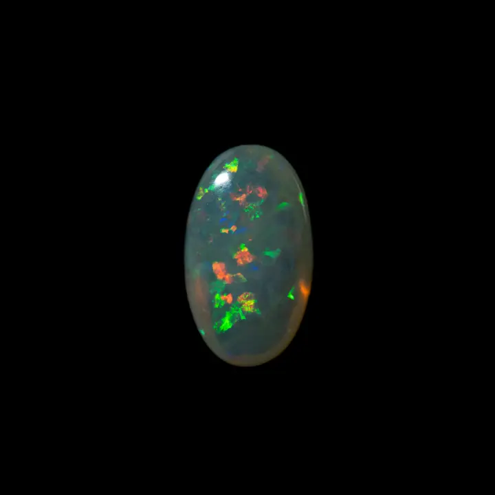 Natural Australian opal from the Lightning Ridge mines, clear crystal oval opal jellyfish type of 3.5 carats with green and orange glints