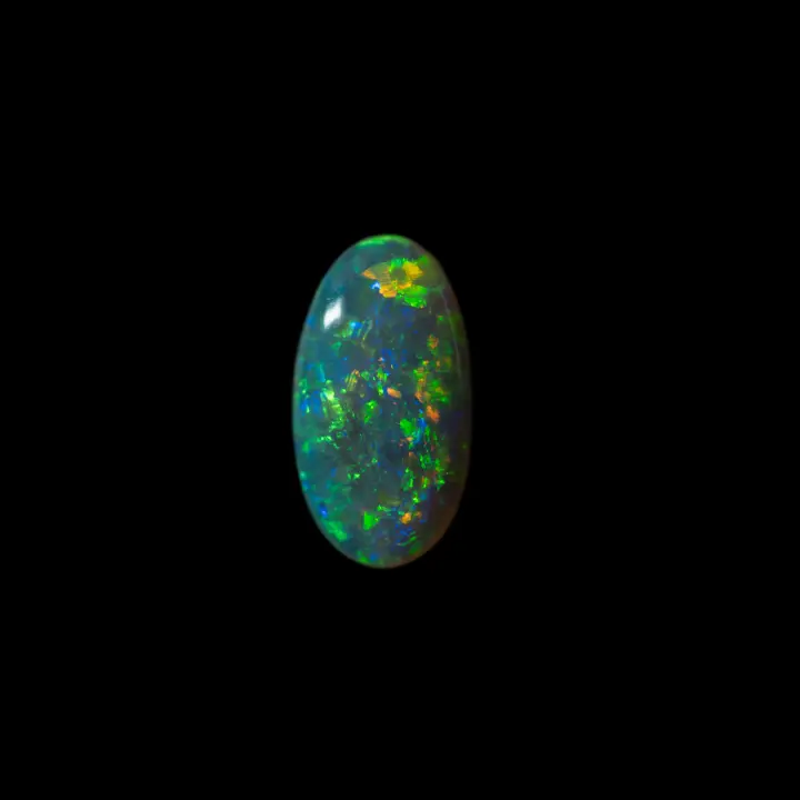 Natural Australian opal from the Lightning Ridge mines, 1.3 carat oval with green, blue and orange brilliance, second face with green rays
