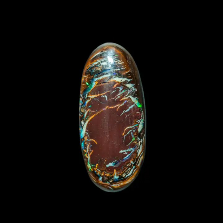 Natural Australian opal from the Koroit mines, oval cabochon of garnet opal in the center framed by colored festoons and green glitter.