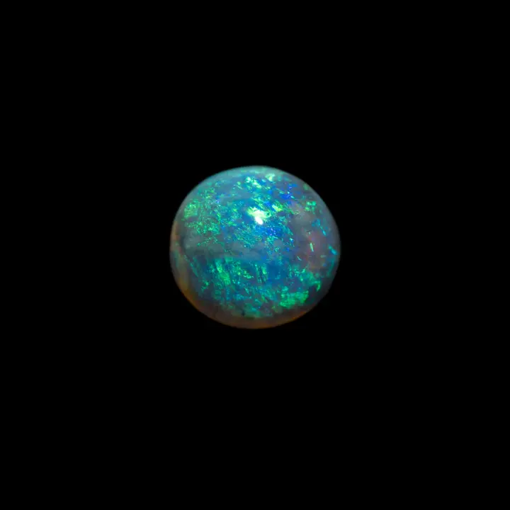 Natural Australian opal from the Lightning Ridge mines, 1.1 carat round brilliant green mixed with indigo blue