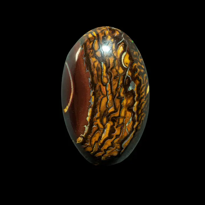 Natural Australian opal from the Koroit mines, 21.3 carat cabochon with ochre, yellow and brown ring decoration surmounted by a bistre zone with clear ring