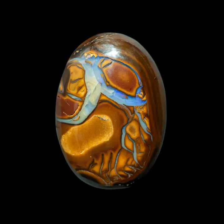 Natural Australian opal from the Koroit mines, large oval cabochon of 20.8 carats with yellow-ochre-brown colored patterns veined with blue opalization.