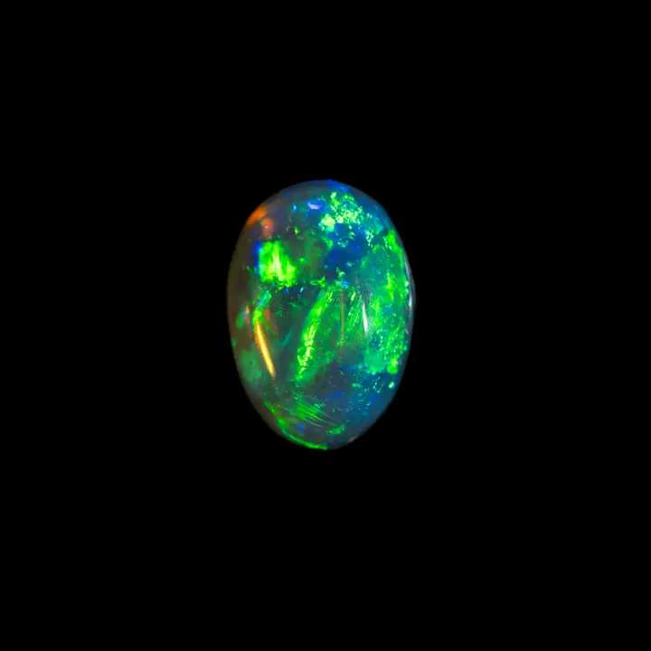 Natural Australian opal from the Lightning Ridge mines, oval dark crystal cabochon of 2.3 carats with intense predominantly green brilliance.