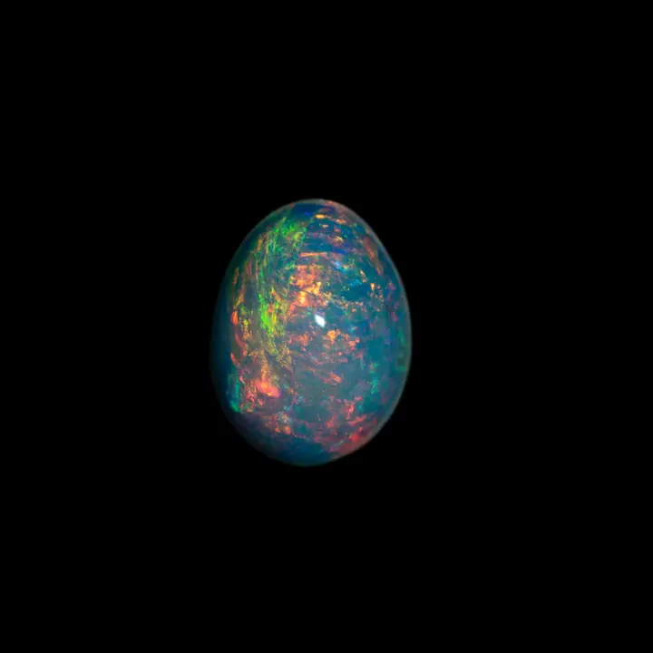 Natural white crystal opal from the Horca mines in Brazil, very clear 2-carat cabochon with multicolored extra-shine on a pink-orange fade.