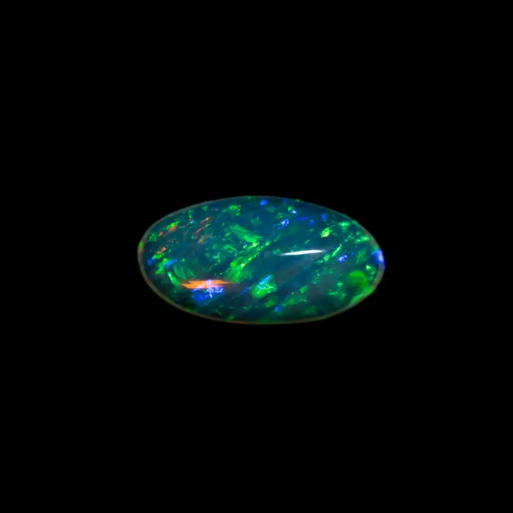 Natural crystal opal from Horca's Brazilian mines, 0.7 carat ovalized cabochon polished on both sides entirely, surrounded by ribbons of green brilliance