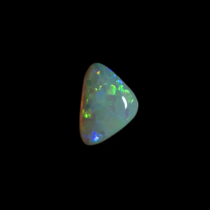 Natural Australian opal from the Coober Pedy mines, 0.9 carat triangular shape with coloured areas in the shape of green and yellow scales
