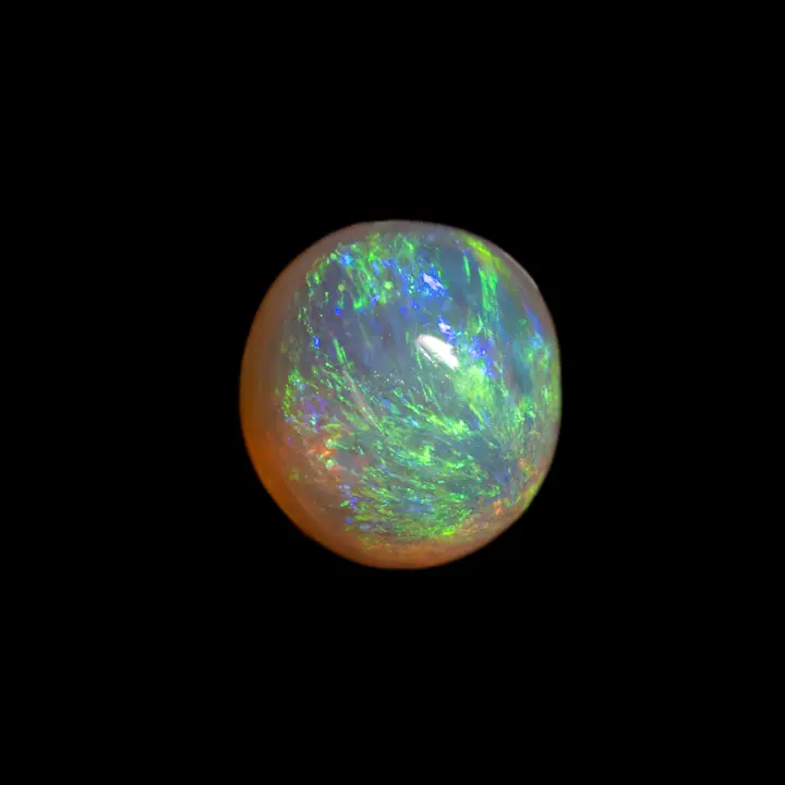 Natural Australian opal from the Lightning Ridge mines, 0.8 carat round shape with green iridescence radiating from one pole