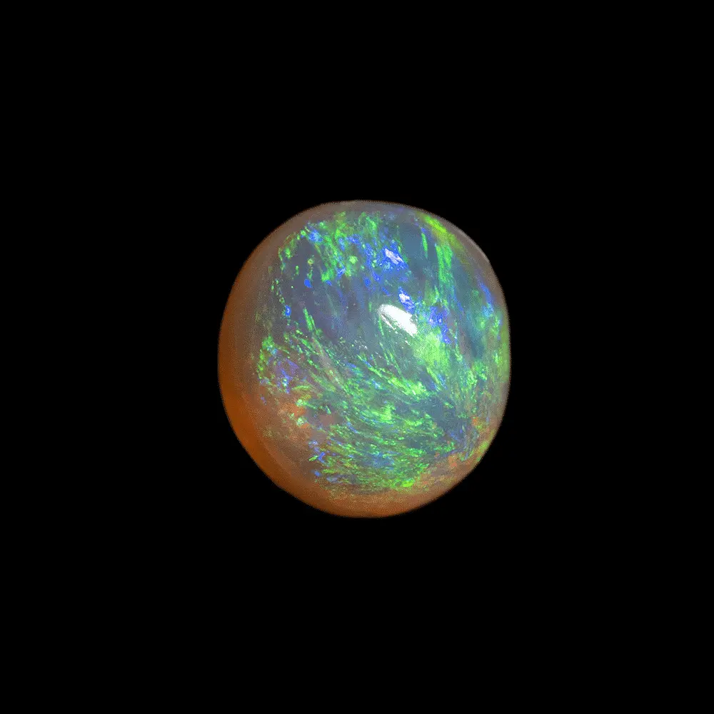 Natural Australian opal from the Lightning Ridge mines, 0.8 carat round shape with green iridescence radiating from one pole