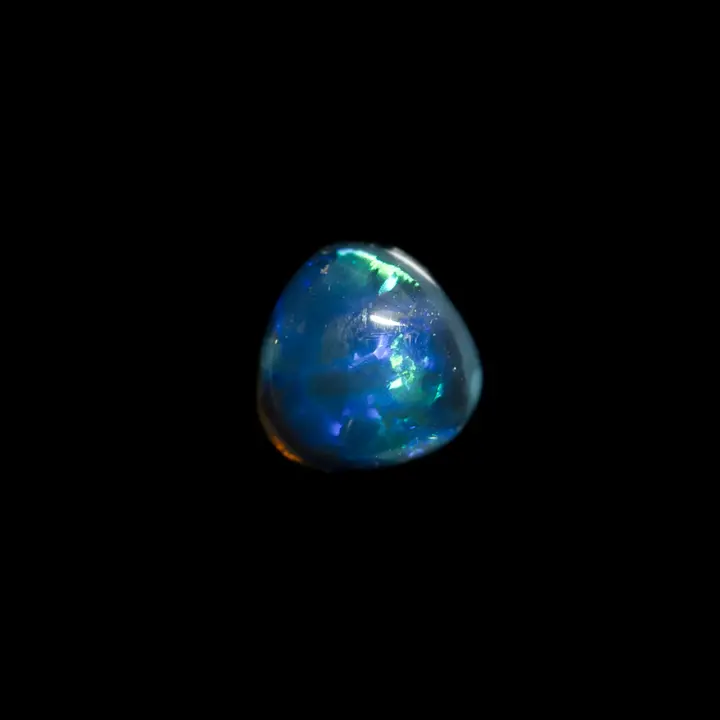 Natural Australian Opal from the Lightning Ridge Mines, 0.8 carat pear-shaped free-form in intense blue, extra black matrix and electric light green shiny sparkles