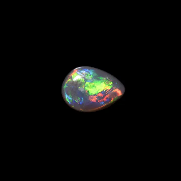 Natural Australian opal from the Lightning Ridge mines, 0.6 carat teardrop shape with dark matrix and wide, very intense blue, green, orange and yellow brilliances