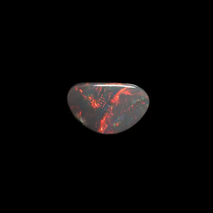 Natural Australian opal from the Lightning Ridge mines, fine free-form 0.7 carat, shiny, with multiple shades of deep reds, oranges and greens