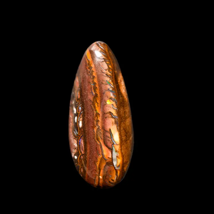 Natural Australian Koroit opal, 25.8 carat teardrop cabochon with red and yellow ochre matrix and fringed designs of green and purple colored shines