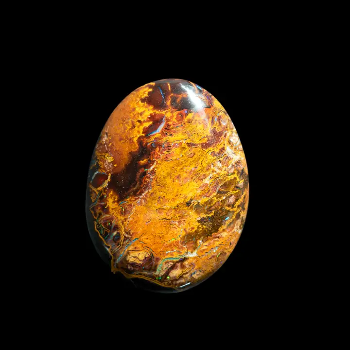 Natural Australian opal from the Koroit mines, 9.9 carat rusty ochre cabochon evoking a landscape crossed by brilliant blue and green streams
