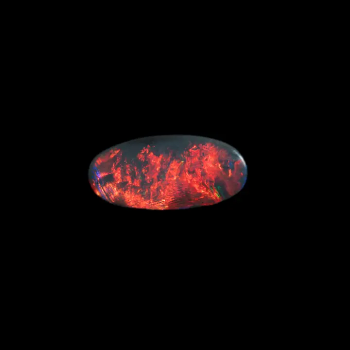 Natural Australian opal from the Lightning Ridge mines, 0.7 carat oval cabochon of a scarlet red and total turning to deep blue under a very closed angle of light