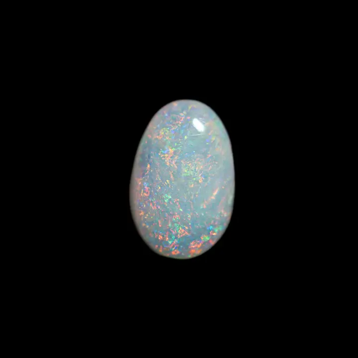 Natural Australian opal from Coober Pedy mines, 1 carat oval cabochon with a very light matrix and multicolored brilliance with predominantly yellow and orange subtly associated