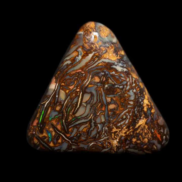 Natural Australian opal from the Koroit mines, triangle shape polished on two sides with colourful, contrasting geometric patterns and studded with brilliance according to the orientation of the faces to the light