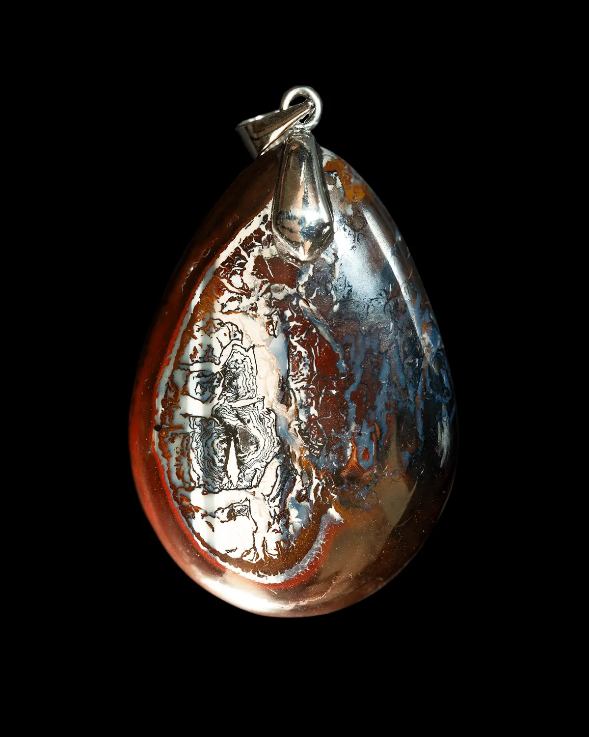 Natural Australian opal from the Koroit mines, a magnificent landscape cabochon with intense contrasting colors; a matrix of dark red oxidized earth contrasting with snow-white, blue-grey and fine black calligraphic patterns.
