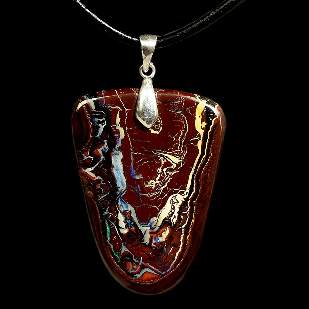 Natural Australian opal from the Koroit mines mounted as a pendant. Large, freeform 67.1-carat opal dangling from a 925 silver XL clasp; contrasting, iridescent blue and green curves.