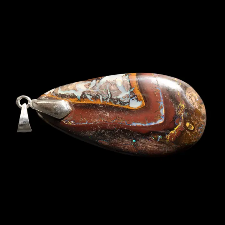 Natural Australian opal from the Koroit mines mounted in a 925 silver pendant. Large 45.5-carat opal teardrop polished on both sides, with bright, colorful designs evoking highly decorative scalloped frames. 