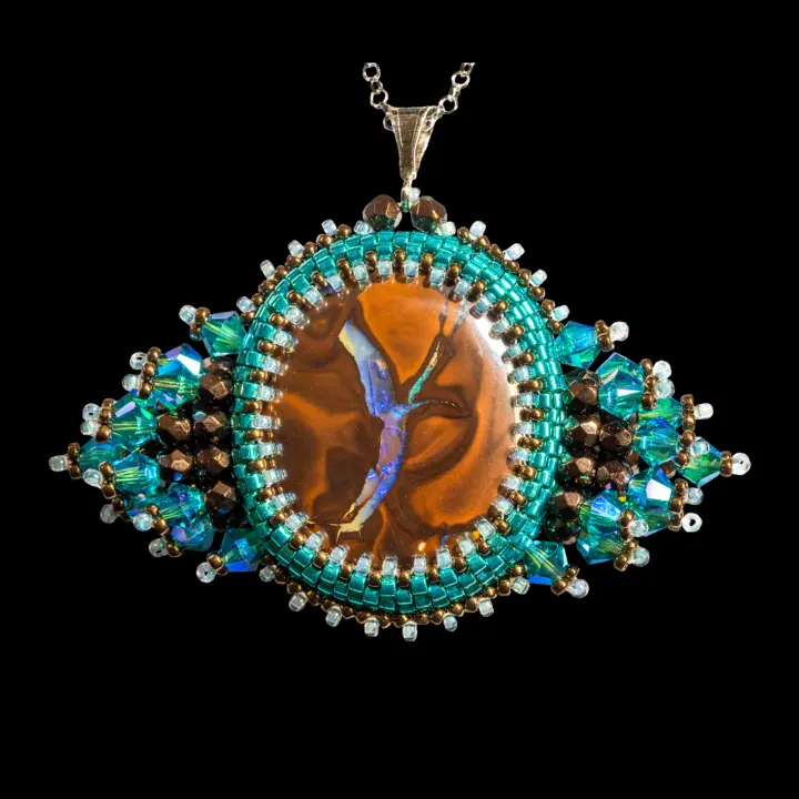Oval Koroit opal cabochon in blue Y (46.2 cts) from the heart of Australia, set in a peyote stitch pattern with Miyuki Delicas glass beads, seed beads, faceted Bohemian glass beads, and Czech crystal spinner beads. 41 cm Jaseron chain, with a rhodium-plated 925 silver bail and clasp.