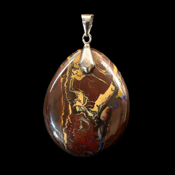 Natural Australian opal pendant from the Koroit mines and 925 silver setting. A drop-shaped cabochon with a wine-red, purple and Naples yellow matrix, punctuated by violet glints. Some may see a figure. 