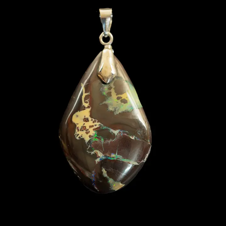Natural Australian opal from the Koroit mines. Mounted in a 925 silver pendant, this beautiful 48.3-carat opal is iridescent with green, sometimes blue, violet and orange depending on the angle of incidence of the light on its brown matrix. 
