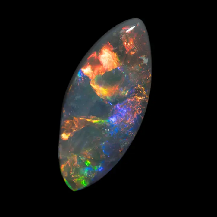 Natural Australian opal from the Lightning Ridge mines, spindle shape polished on one side to 2 carats, large slabs and multicolored iridescent filaments, its great color variability and intense brilliance make it an exceptional opal.